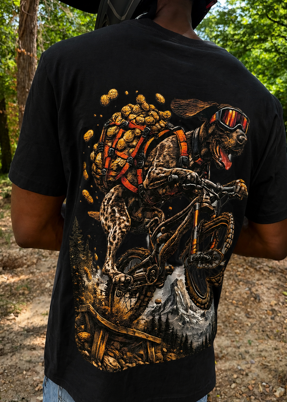 Person wearing a black t-shirt with a graphic design of a motorcycle and rider, standing outdoors.